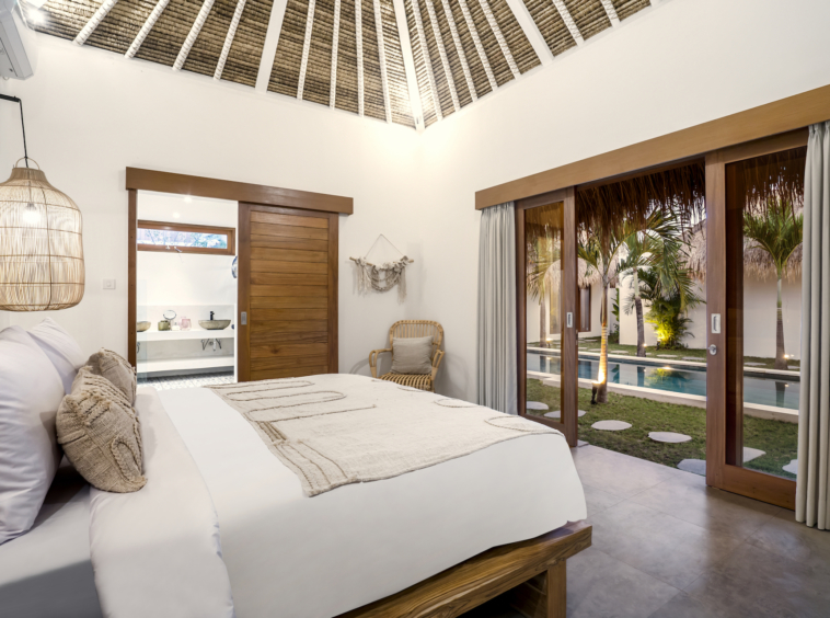 Just walking distance to Seminyak beach, a bedroom with a pool and garden view only at Cocotier Seminyak Villa