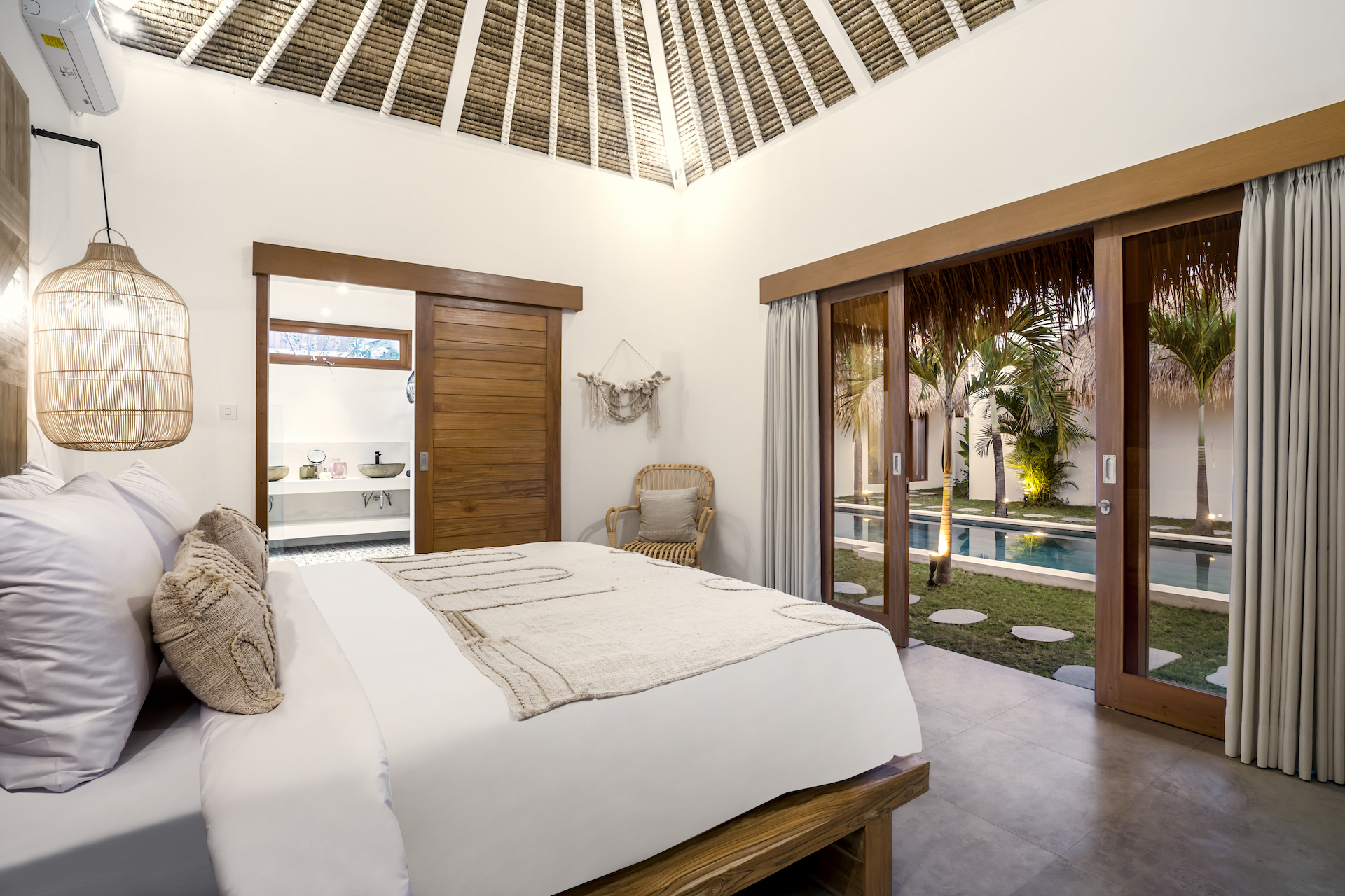Just walking distance to Seminyak beach, a bedroom with a pool and garden view only at Cocotier Seminyak Villa