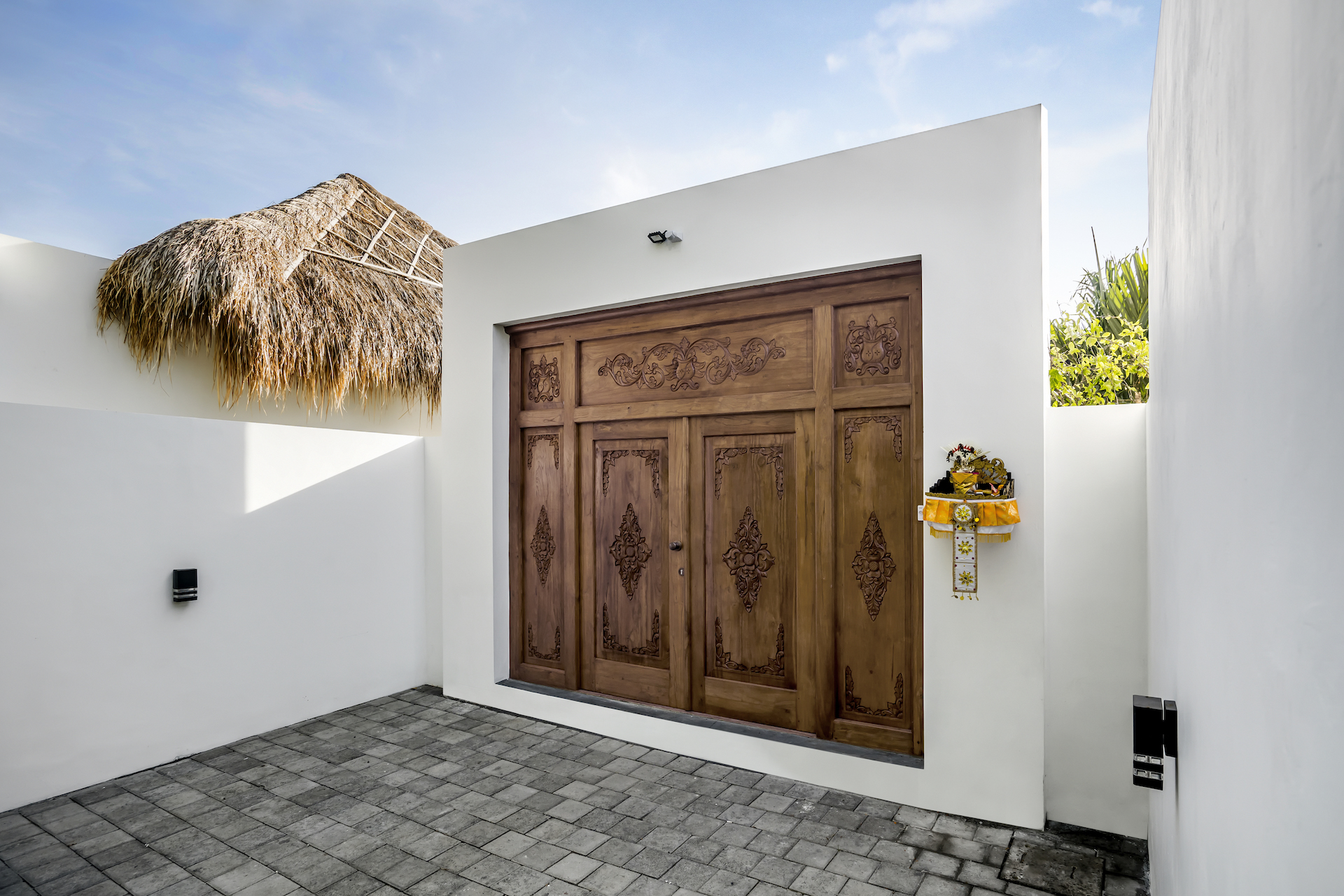 Parking area with the wooden entrance gate at Cocotier Seminyak villa walking distance to Seminyak beach Bali